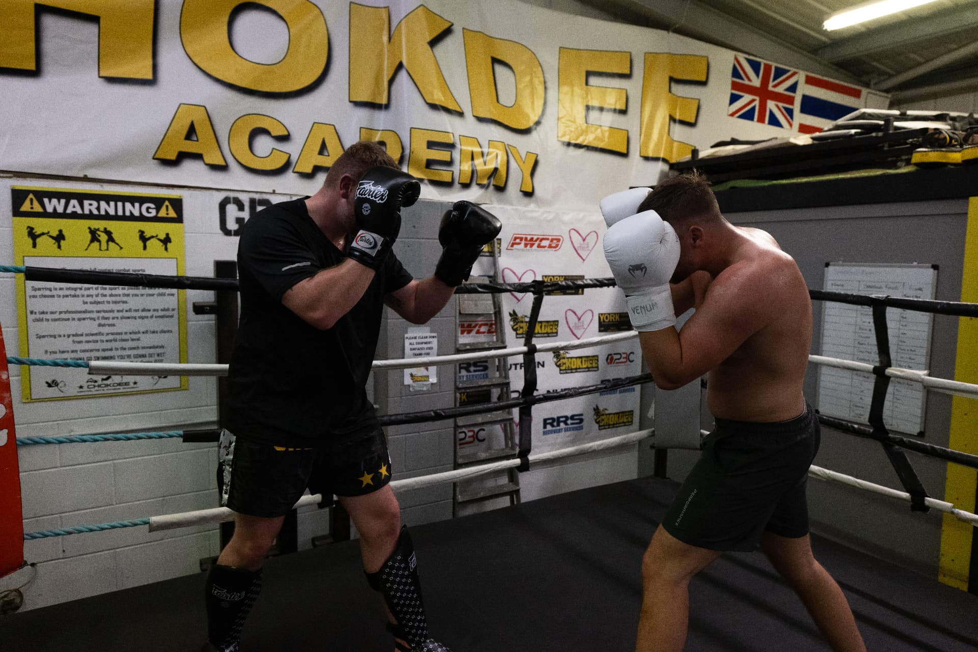 Two members trading punches in the ring under the Chokdee Academy banner