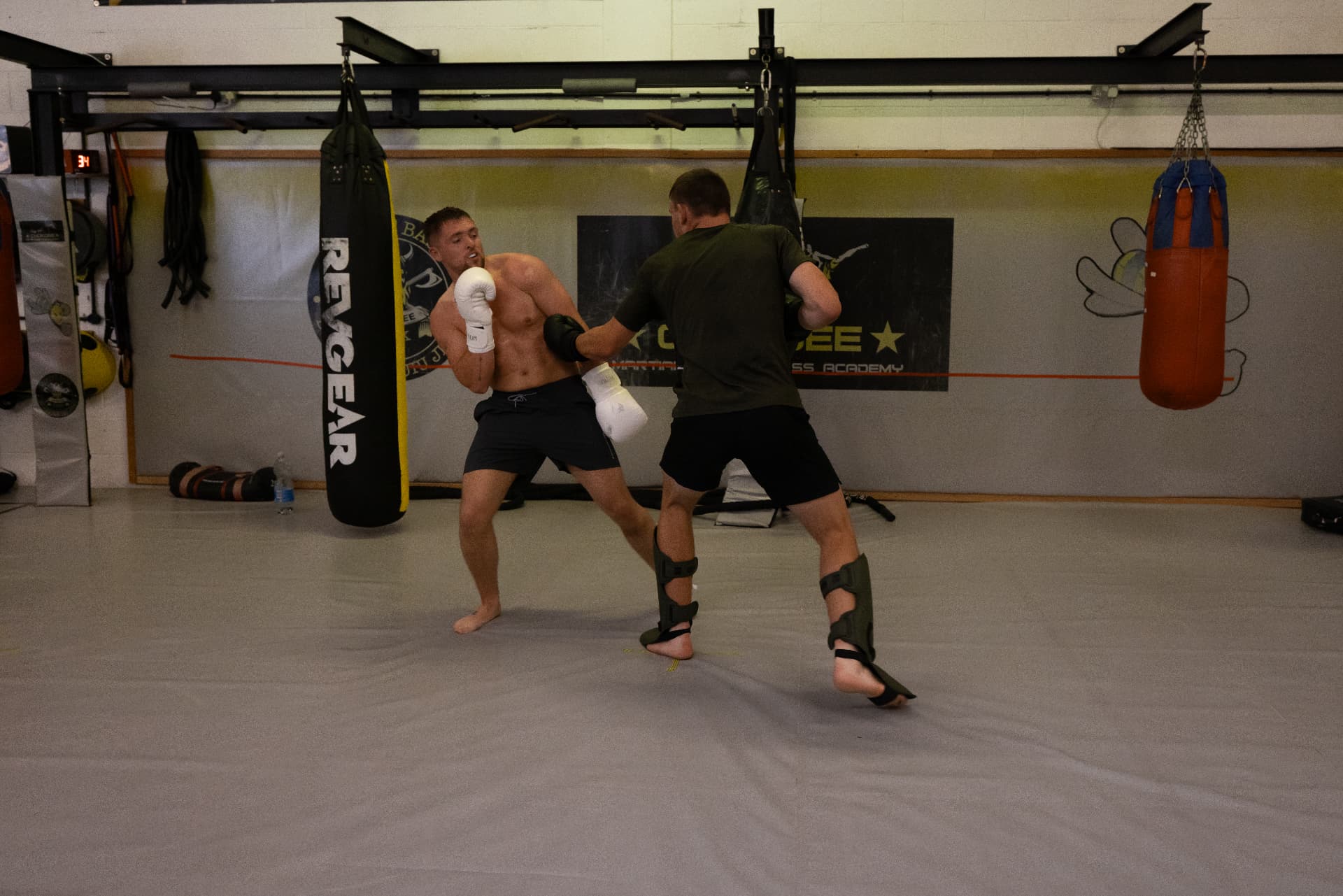 Member digging a body shot during a Muay Thai sparring round