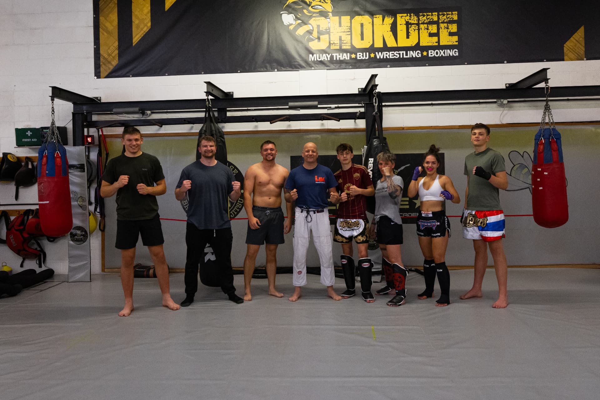 The Chokdee training group lined up under the academy banner
