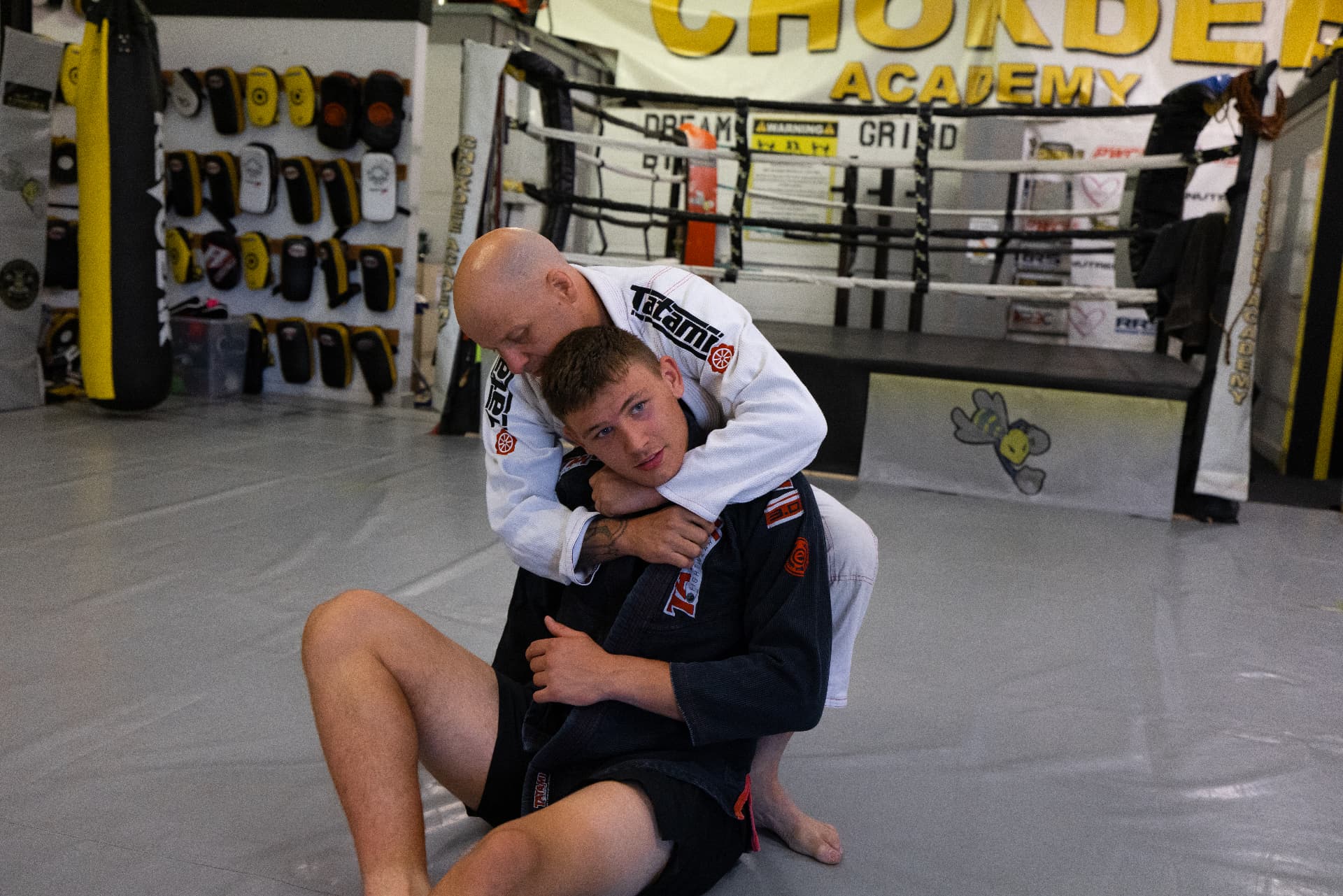 Coach demonstrating a back take in gi jiu-jitsu